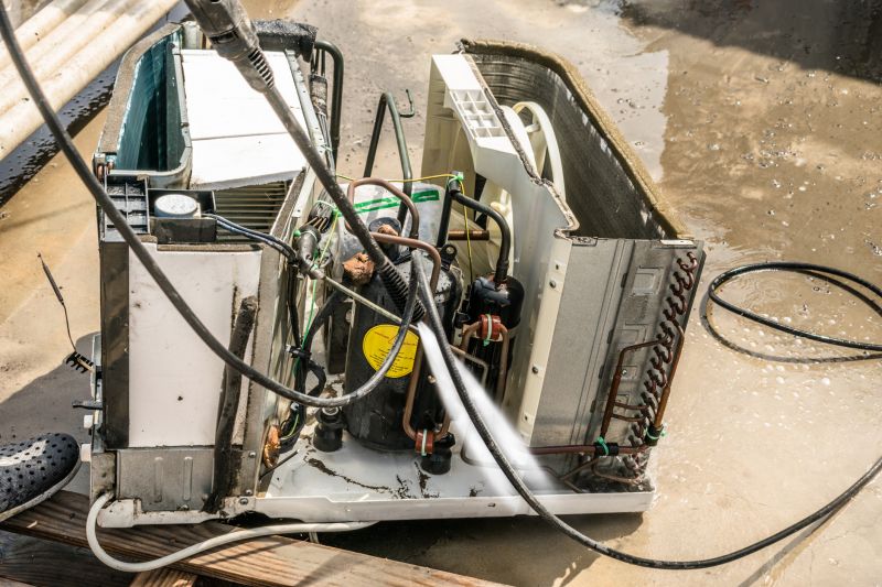 Technician Cleaning Coils